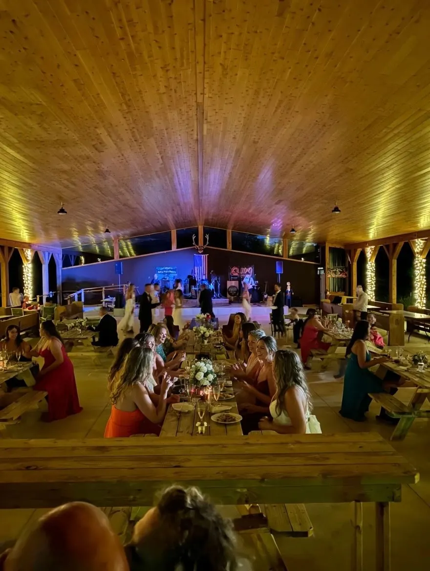Evening reception under string lights inside the Lakeside Pavilion