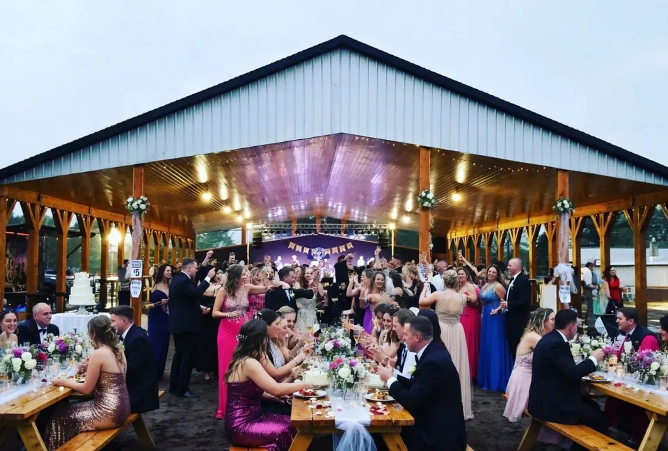 Wedding reception guests dining under the Lakeside Pavilion
