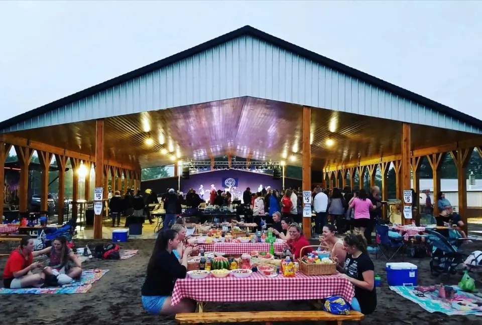 Guests at long tables in the Lakeside Pavilion